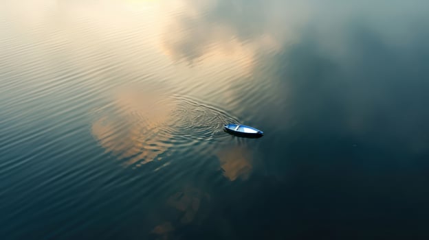 A small boat floating in the water photo