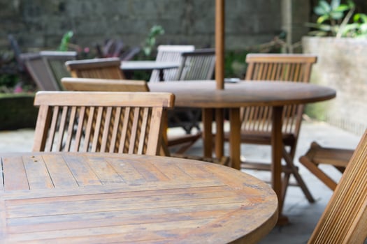 Empty wooden chairs and tables in restaurant outdoor photo