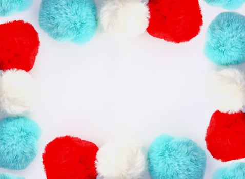 Colorful fluffy pompons on white background. Fashion decoration festive template. Design element for poster, banner, web, greeting card. photo