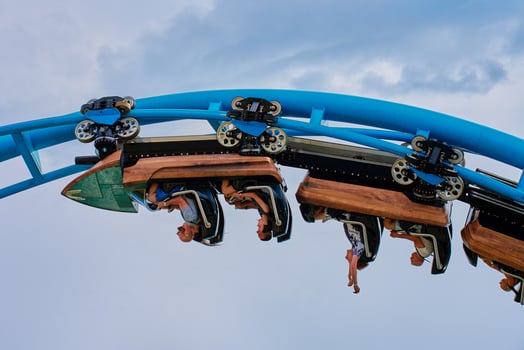 Theme park Energylandia in Zator, Poland. People riding at roller coaster attraction in amusement park. Entertainment at summer holiday. Zator, Poland - May 31, 2024 photo