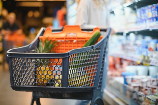 Shopping cart with products in a supermarket photo