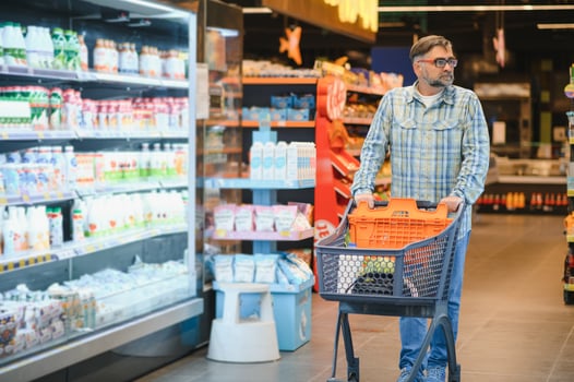 Senior man at grocery store products photo