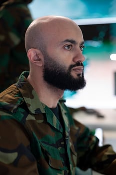 Army captain oversees special operation to gather intelligence, analyzing important data for a national defense mission. Major targeting enemy vessels on radar CCTV system in power base. photo