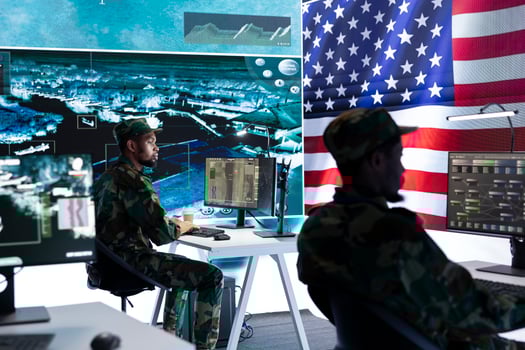 US military officer supervising threat detection activity in high tech office, examining top secret data on big screen. American army soldiers managing hybrid war, cyber attack prevention. photo