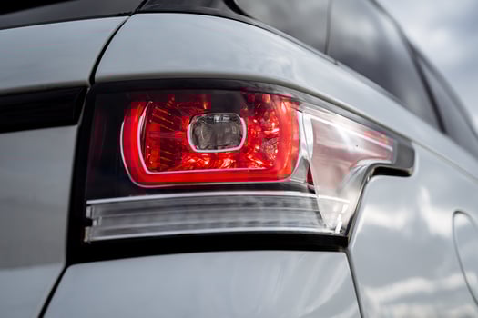 Car taillight, red brake light, right rear fender of the car, glass headlight, xenon, crossover white. photo