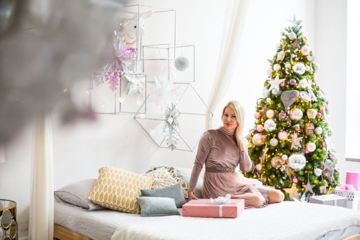Cheerful pretty young woman having got a Christmas present photo