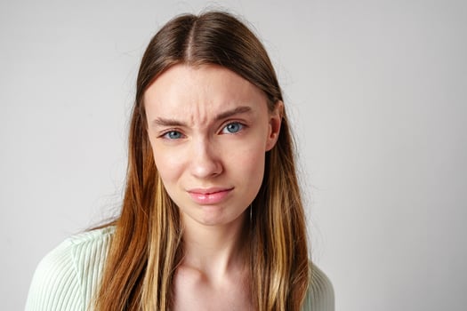Portrait of Young Woman With Frowning Expression photo