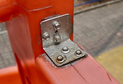 Heavy duty bolt metal connection on outdoor orange colored steel bar object background. photo