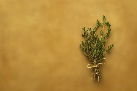 An isolated bundle of dried herbs is tied together with twine, showcasing its rustic beauty against a warm, textured background. The arrangement exudes a natural, calming essence. photo