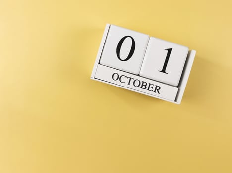 flat lay of wooden calendar with date October 1st. on yellow background,copy space. Calendar. photo