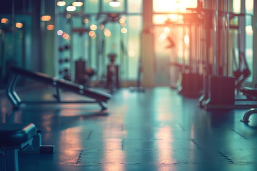 Soft blurred gym background, active fitness equipment and strong workout mood. photo