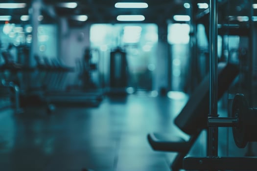 Soft blurred gym background, active fitness equipment and strong workout mood. photo