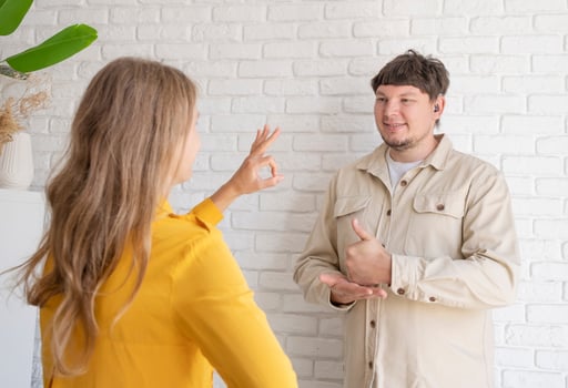 young woman and deaf man with audiology implant, service or help for sound waves photo