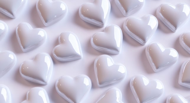 Glossy white heart-shaped decorations arranged neatly on a soft background for festive occasions photo
