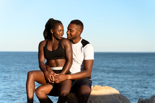 Cheerful woman wearing sports clothes smiling while embracing with her boyfriend photo