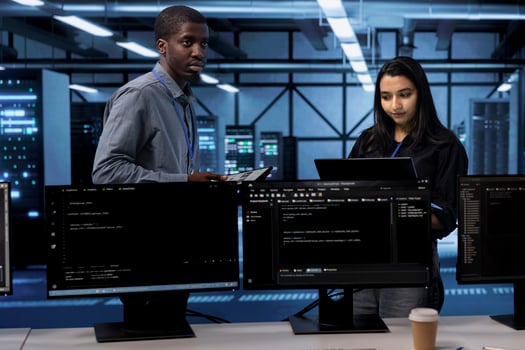 Technicians in data center using devices to check for server performance issues arising due to high CPU usage. Server farm staff members fixing insufficient memory errors slowing down hardware photo