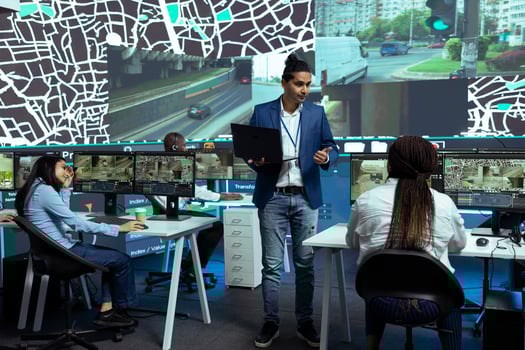 Indian supervisor handles express delivery orders through city traffic, working with his team to provide alternative routes via satellite navigation and CCTV footage. Gps tracking system. photo