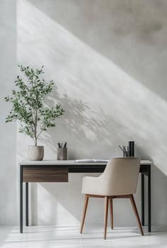 Minimalist workspace with a sleek desk, chair, and a simple plant adding a touch of greenery photo