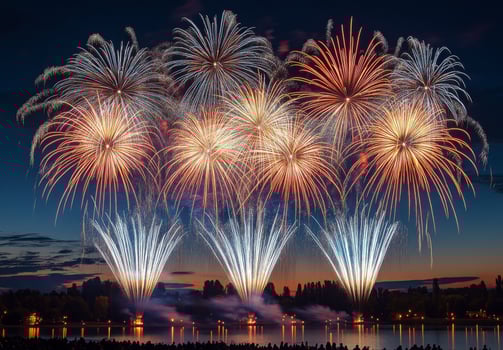 A spectacular finale of fireworks, with layers of colors and light filling the sky over a lake photo