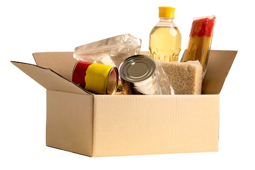 Foodstuff for donation isolated on white background with clipping path, storage and delivery. Various food, pasta, cooking oil and canned food in cardboard box. photo