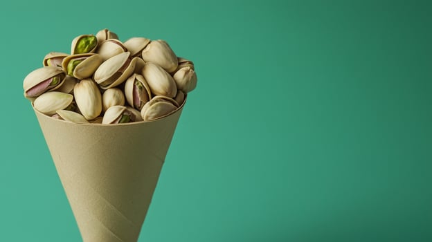 Pistachios on brown paper wrapped eco friendly container photo