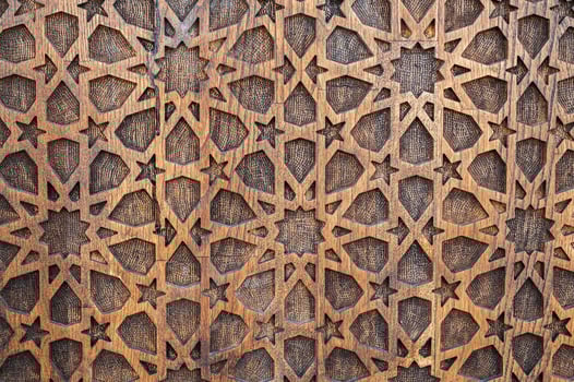arabic Uzbek Islamic patterns ornament with stars on wooden carved door in Uzbekistan close-up photo