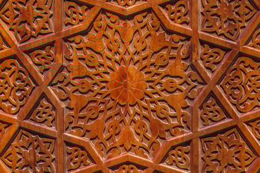 traditional Arabic Uzbek Islamic patterns arabesque ornament on an wooden carved door in Uzbekistan photo
