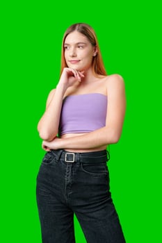 Woman With Long Hair Contemplating While Posing Against a Green Screen photo