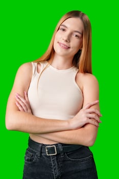 Woman Wearing Black Jeans and a Purple Top Posing in Front of a Green Screen photo