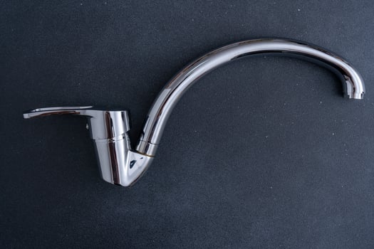 Chrome-plated mixer tap for water in the bathroom and kitchen. Plumbing. photo