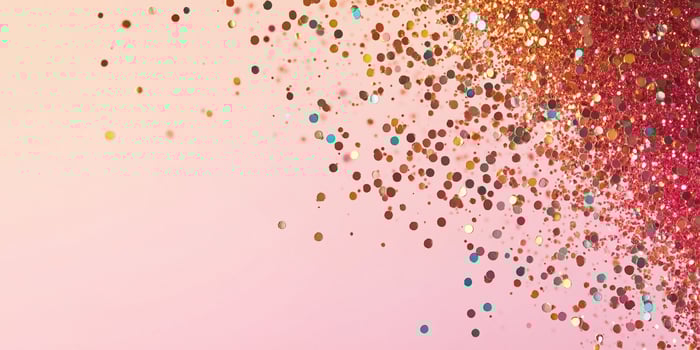 Sparkling glitter spreads across pastel surface photo