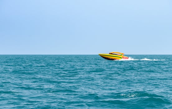 Speedboat sailing on the blue tropical sea on the background clear blue sky morning day at Koh Larn island. Speed boat running on the bay, Panorama ocean, Pattaya, Thailand, Vacation. photo