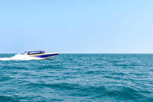 Speedboat sailing on the blue tropical sea on the background clear blue sky morning day at Koh Larn island. Speed boat running on the bay, Panorama ocean, Pattaya, Thailand, Vacation. photo