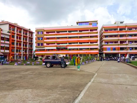 Cross View Of Orange And White School Building With Parking And Bared Walkways photo