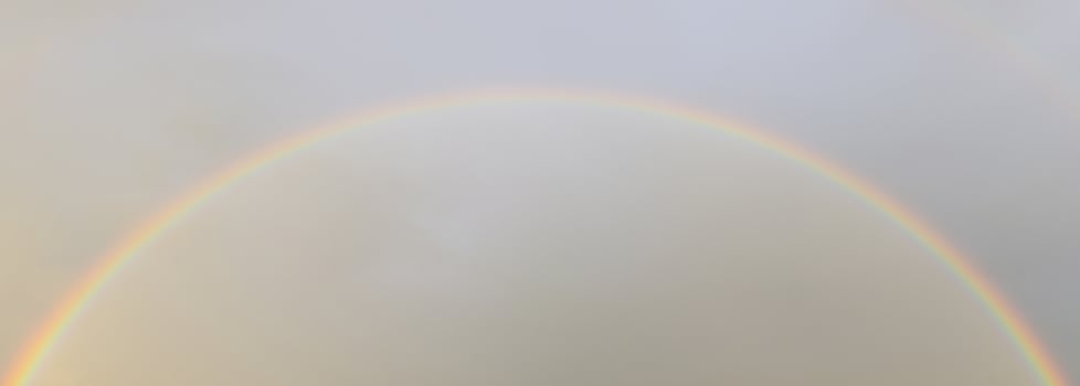 Rainbow against sunset sky. Natural background. Weather after rain. photo