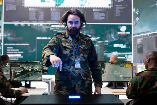 Military personnel examining global satellite CCTV footage on a hologram, monitoring infantry unit soldiers deployed in the field. Trained recruit employing holographic projection. photo