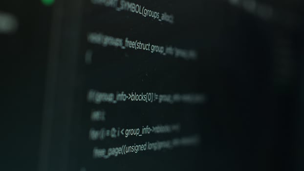 Extreme close up shot of hacking code running on computer system monitors attacking firewalls. Programming scripts shown on PC screen used by cyber criminals to breach security photo