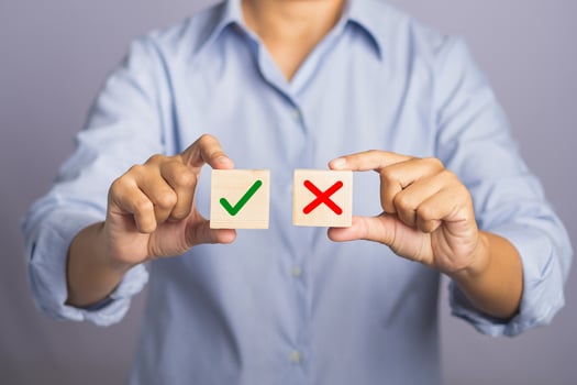 Choice Accept and Decline concept. Hand of holding two wooden cubes with text yes and no for choice while standing with gray background photo