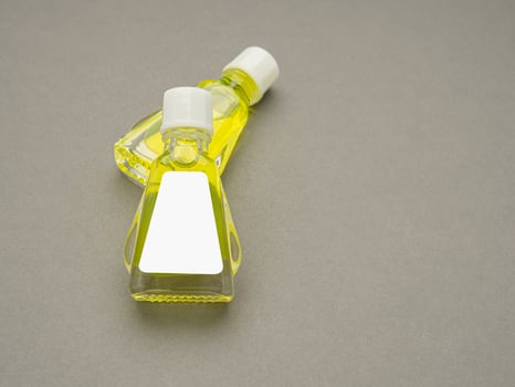 Small bottle containers with yellow herbal. Blank label for branding mockup. Natural beauty and health product concept photo