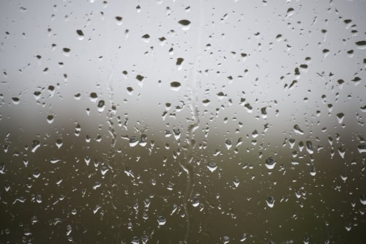 The raindrops on the window are small and numerous photo