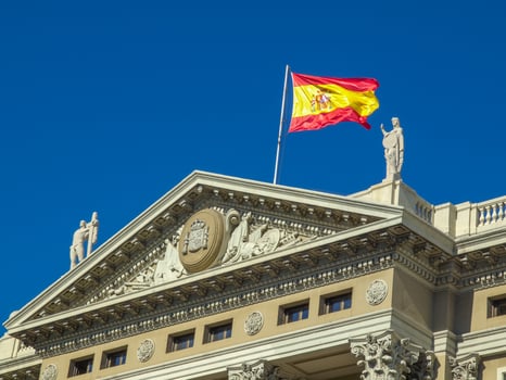 A building with a spanish flag on top photo