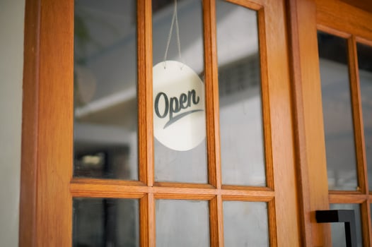 Open sign hanging on the door glass at the coffee shop. Open sign board at the cafe, coffee shop, hotel, cafe restaurant or retail store photo
