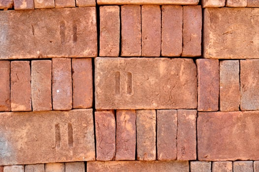 Pile of red bricks texture background photo