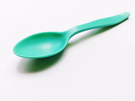 Green Spoon isolated on white background photo