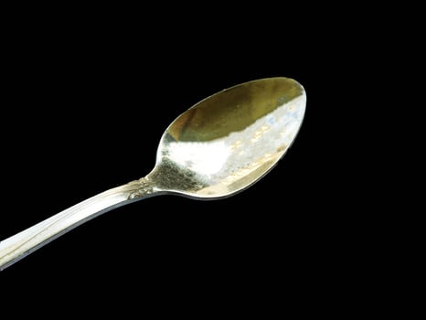 Steel Spoon isolated on black background photo