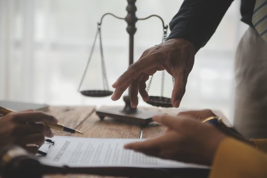 Business and lawyers discussing contract papers with brass scale on desk in office. Law, legal services, advice, justice and law concept picture with film grain effect photo