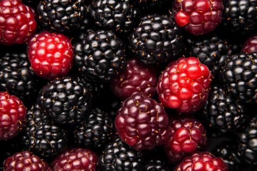 A close up of a bunch of blackberries and raspberries photo
