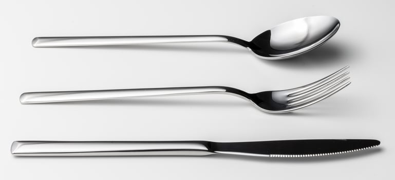 Spoon, fork and knife on a white background photo
