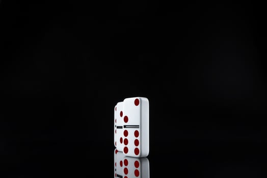 Domino game. Dominoes on a black table photo