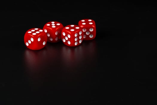 Group of dice close up on dark black background photo